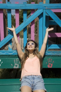 Asian woman cheering outdoors