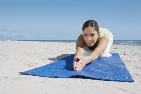 Hispanic woman practicing yoga