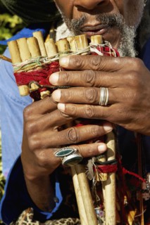 Close up of African man playing pan flute