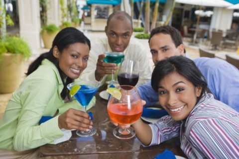 Hispanic couples toasting with cocktails