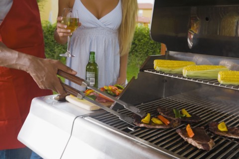 Multi-ethnic couple barbecuing