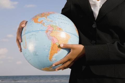 African businesswoman holding globe