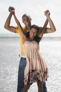 Multi-ethnic couple holding hands at beach