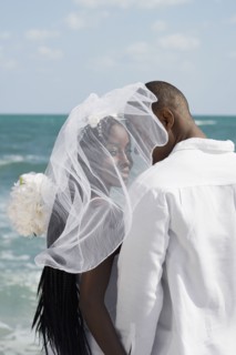 African bride and groom at beach