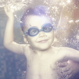 Caucasian boy swimming under water