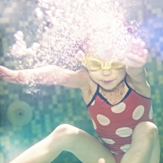 Caucasian girl swimming under water
