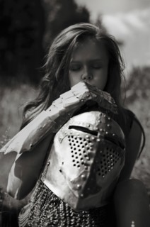 Caucasian girl carrying armor outdoors