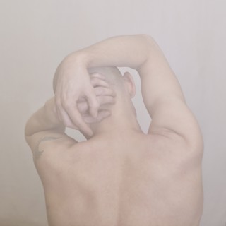 Caucasian man clutching his head
