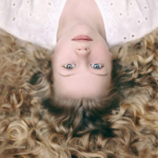 Caucasian girl laying on ground