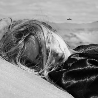 Caucasian woman laying outdoors