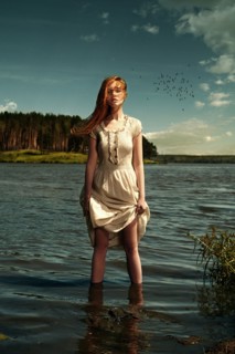 Caucasian woman standing in remote lake