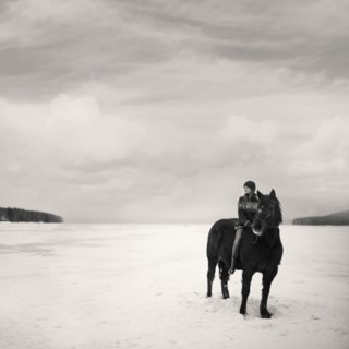Caucasian girl riding horse in snowy field