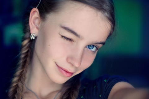 Caucasian teenage girl winking