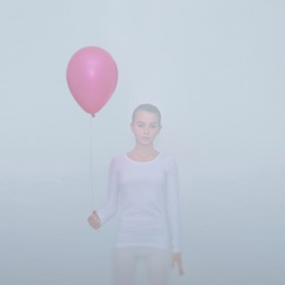 Caucasian teenage girl holding balloon