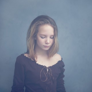 Caucasian teenage girl looking down
