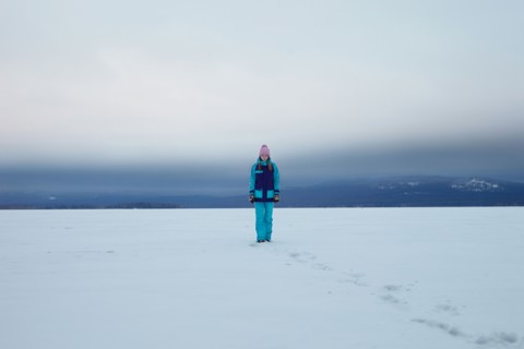 Caucasian teenage girl walking in snow