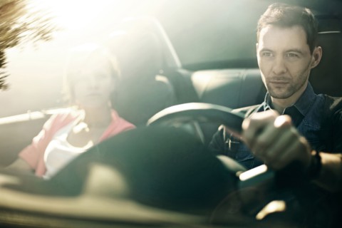 Caucasian father and daughter driving in car
