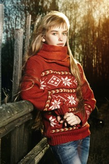 Caucasian girl leaning on fence