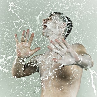 Caucasian man splashing in milk