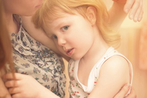 Caucasian mother hugging preschooler daughter
