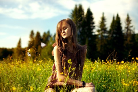 Caucasian woman sitting in field