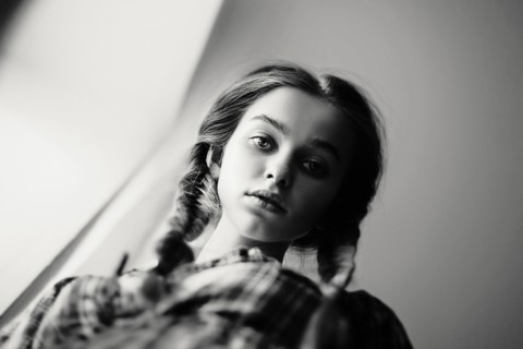 Low angle view of serious Caucasian teenage girl