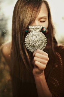 Close up of Caucasian woman showing medallion