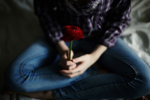 Caucasian teenage girl holding flower