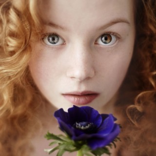 Caucasian teenage girl holding flower