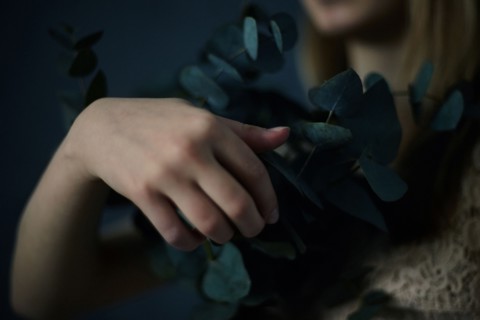 Caucasian teenage girl holding plants