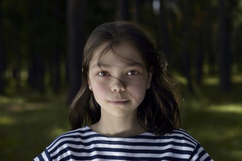 Serious Caucasian girl in forest