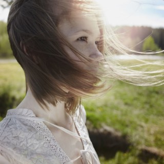 Caucasian girl with hair blowing in wind