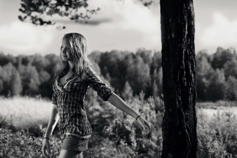 Caucasian girl walking near tree