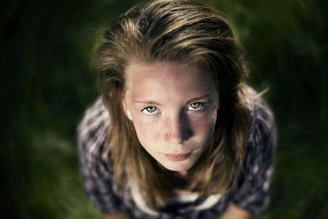 Serious Caucasian girl looking up