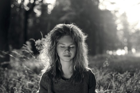Caucasian girl with eyes closed in field