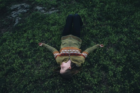 Caucasian woman laying in grass