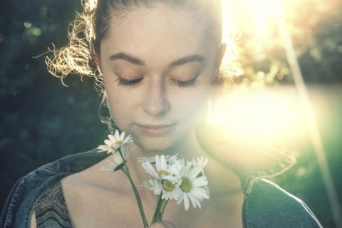 Caucasian woman smelling flowers