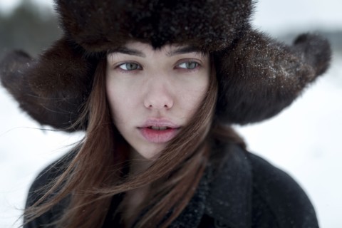Serious Caucasian woman wearing fur hat and coat in winter