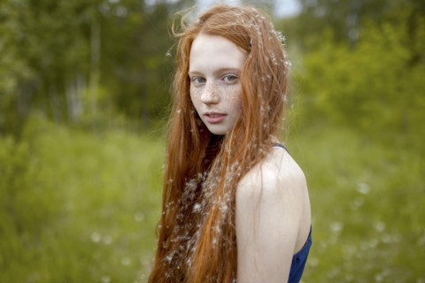 Caucasian girl with dandelion seeds hair