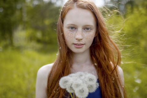 Caucasian girl with dandelion seeds hair