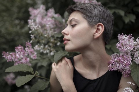 Profile of Caucasian woman standing in flowers