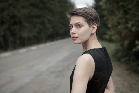 Caucasian woman standing near road