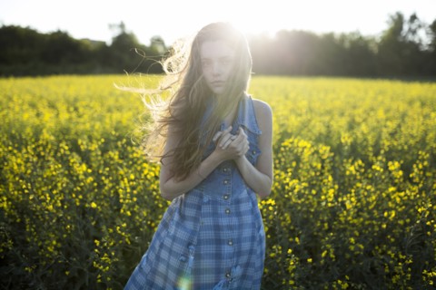 Portrait of Caucasian woman standing in windy field