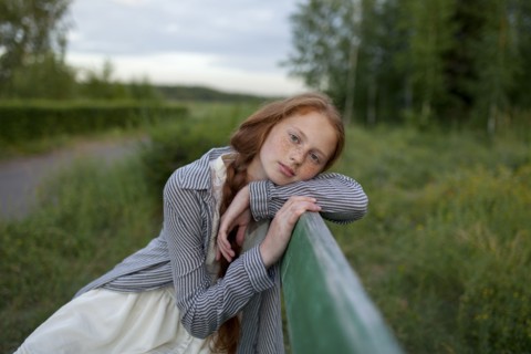 Portrait of pensive Caucasian girl sitting on bench