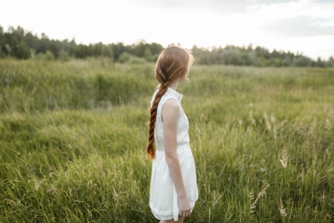 Caucasian girl standing in field