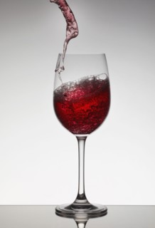 Red wine filling wine glass