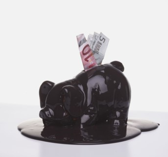 Euro banknotes in melting piggy bank