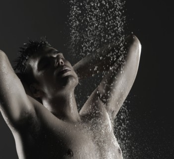 Caucasian man standing in shower