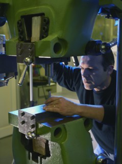 Caucasian worker using industrial drill