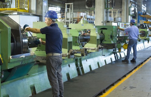 Caucasian workers working in steel factory